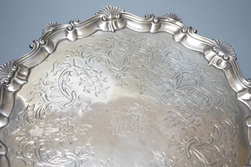 A late George II silver salver, with later engraved decoration, Ebenezer Coker, London, 1758, diameter 32cm, 25.5oz.